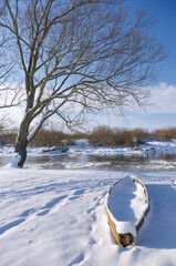 A wooden boat moored at the bank