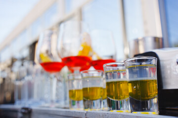 Colorful shots lined up at a festive outdoor bar