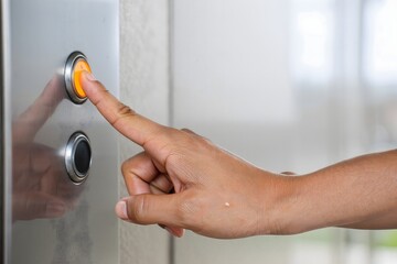 Pressing elevator button finger pushing lift floor call panel control up