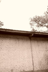 Sepia Toned Woven Bamboo Wall with Corrugated Metal Roofing Edge Building © RifaldiMuhammadSalim