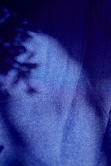 a blue fabric that is on a table with a shadow