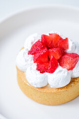 Strawberry cheese tart on a white plate