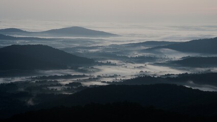 A smoky cloud inversion waits for dawn in Shenandoah National Park. Fog as thick as smoke fills the cold Virginia valleys in this moody pre-dawn landscape. 