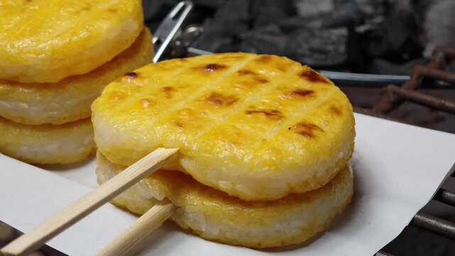 Khao jee: a street style Thai style grill sticky riceon the charcoal turtle with egg paste. 