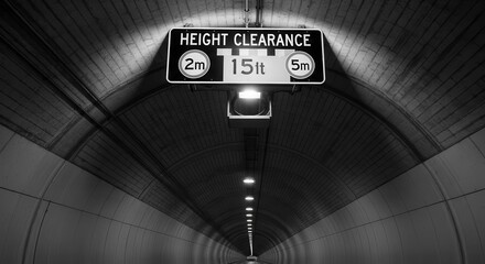 Tunnel Perspective Of Clearance Signage With Dimly Lit Lighting And Architectural Details