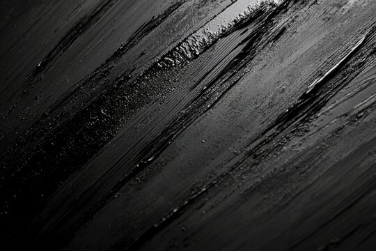 Fototapeta Black and white photograph of a person walking alone in the rain under an umbrella