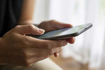 Close-up of a smartphone in the hands of a young woman.