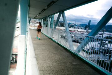 Young woman running on bridge path outdoors