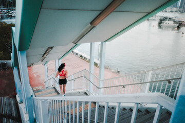 Young woman running on bridge path outdoors