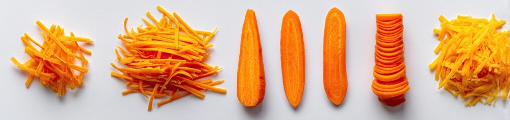 Carrots, various cuts, on a white surface