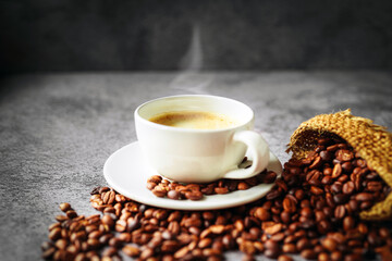 Coffee cup and coffee beans in sack on gray background, Espresso crema coffee cup aromatic
