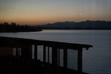 Obraz premium Sunset lake view from veranda with reflections.