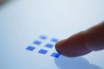 Fingertip Touching Blue Grid Pattern on Luminous Screen Interface Digital Device Navigation Control Light Technology Background