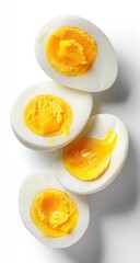Four halved eggs, yolks visible, light background