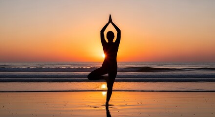 Silhouette of woman in tree pose at sunset beach