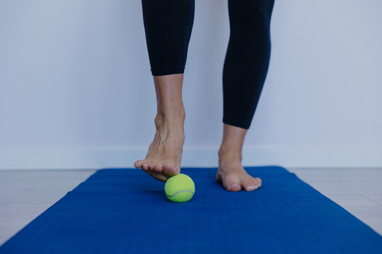 performing barefoot drills with small balls to improve stability and strengthen toes manually