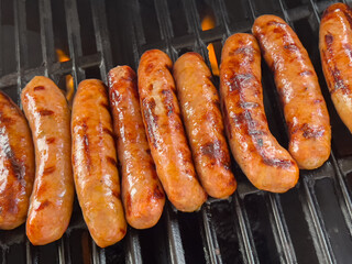 Sausages with deep grill marks and glossy finish