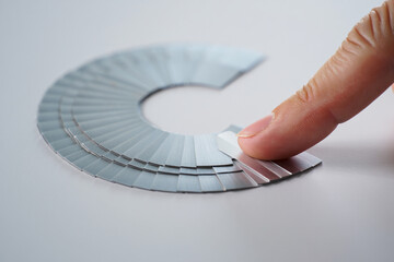 Dental Shade Guide Displaying Variety of Shades Being Held by Person for Precise Color Matching in Cosmetic Dentistry Indoors