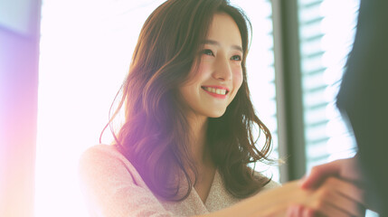Business & Creative Work (Hybrid) – adult Japanese woman (long hair), handshake after meeting (generic), 16:9, right copy space