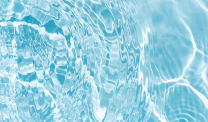 Blue water with ripples on the surface. Defocus blurred transparent blue colored clear calm water surface texture with splashes and bubbles. Water waves with shining pattern texture background.