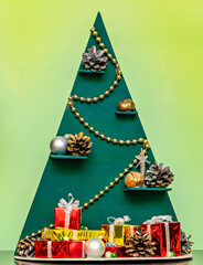 A christmas tree made out of a cardboard box with presents on it