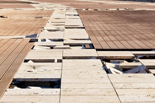 Broken paving creating an uneven surface, depicting neglect, construction issues, maintenance problems, and potential danger