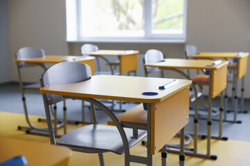 Stylish classroom with desks and chairs at school, closeup