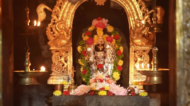 Worshipping Lord Hanuman. Priest offering prayers to Hindu god Hanuman in Temple.