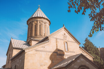Tbilisi Sioni Cathedral facade and dome under a clear blue sky, highlighting ancient Georgian Orthodox architecture and sunlight
