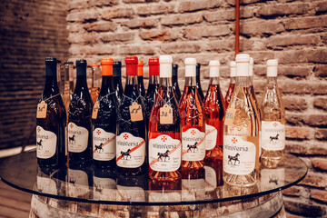 Fototapeta premium 31 October 2025, Tbilisi Wine museum, Georgia: Various wine bottles, including red, rose, and white, arranged for display with price tags