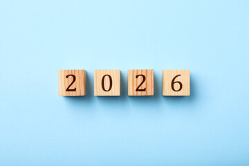 New 2026 year. Cubes with numbers on light blue background, top view