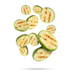 Grilled pieces of zucchini falling on white background