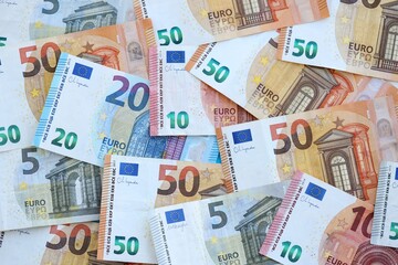 Euro money bills banknotes in big amount on table close up. Huge quantity of European Union currency cash on smooth surface. Business and rich life concept