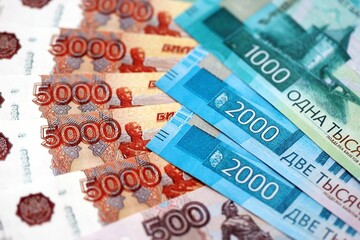 Russian ruble money bills banknotes lies in big pile on table close up. Concept of finances and...