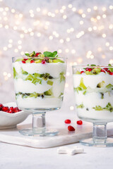 Colorful fruit parfaits showcase layers of creamy yogurt, fresh kiwi, and bright pomegranate seeds. These delightful desserts are perfect for celebrations and add a touch of elegance.