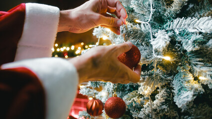 Snowy Christmas tree and Santa Claus hanging red balls