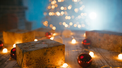 Man arranges Christmas presents on table with colored lights