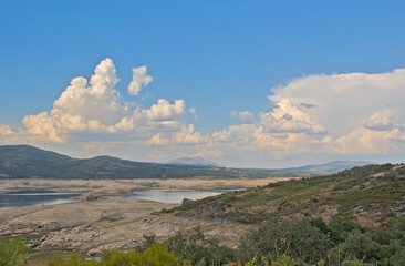 Naklejka premium Rabagao river and surrounding mountains with high cumulus clouds, Viade de Baixo, Montalegre, Portuga