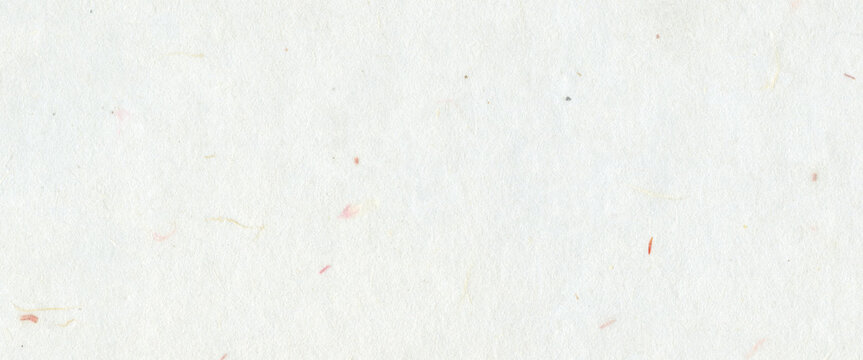 White handmade paper with subtle fiber textures and small colorful flecks. Organic and recycled mulberry paper background concept for craft art