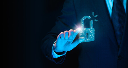 A man presses a glowing holographic icon of a hacked lock.