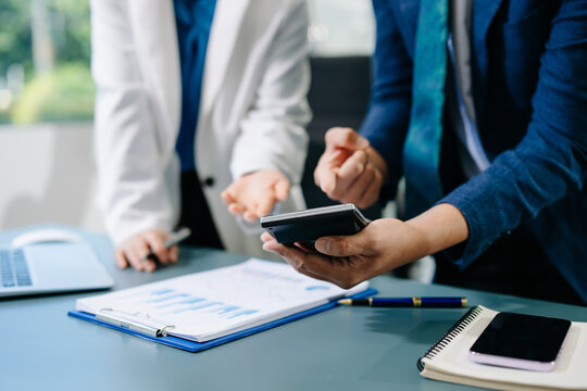 Team business meeting presentation. Hand businessman working project in modern office.Laptop computer and tablet and smart phone on white desk