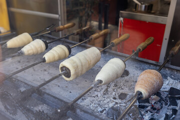 Hungary. Budapest. Preparation of traditional Kurtos Kalacs in the bakery.
