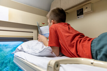 Russia. Krasnodar. The child is on the top shelf in the train compartment.