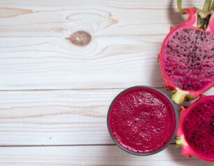 Dragon fruit smoothie and cut dragon fruit on a wooden surface.