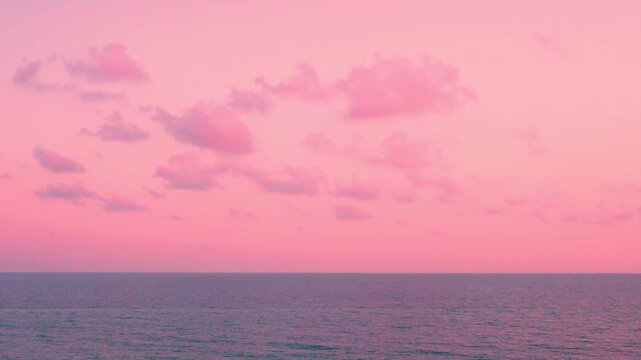 Amazing sea view and pink sky colorful clouds and sun horizon time lapse. 4K Rose seascape calm ocean and pink sunset colored skyscraper with cumulus clouds in sunlight timelapse, beach travel vacatio