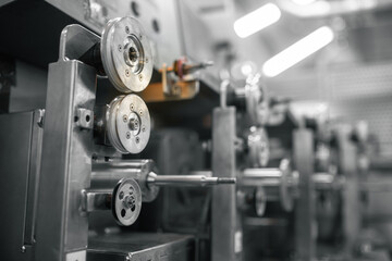 Industrial machinery showcases intricate components and precise engineering within a factory setting.