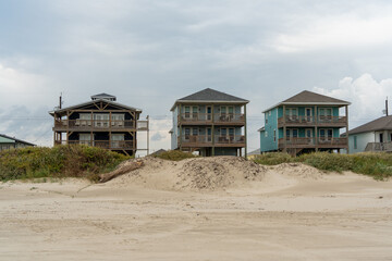 Colorful beach houses built on stilts to prevent storm damage