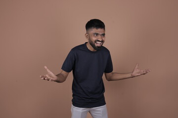 Animated young man gesturing with open palms – concept of confusion, surprise, emotion, reaction, and expressive body language