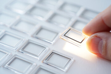 Hand Choosing Square Frame with Black Border in Array for Selection Concept on White Background with Light and Shadow