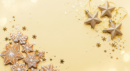 Flat lay of star-shaped cookies with white icing, golden star ornaments, and scattered confetti on a beige surface, symbolizing holiday festive spirit